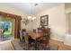 Dining room with wood floors, with sliding glass door to lanai at 2428 Maverick Way, The Villages, FL 32162