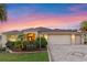 Inviting home with a well-kept lawn, mature landscaping, and an expansive three-car garage at 2428 Maverick Way, The Villages, FL 32162
