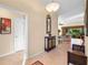 Spacious foyer with tile floors, a hall tree, and view to the living room at 2428 Maverick Way, The Villages, FL 32162
