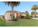 Charming home with a well-manicured lawn, beautiful landscaping, and palm trees at 2428 Maverick Way, The Villages, FL 32162