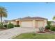 Charming home with a three-car garage, beautiful landscaping, and a brick-paved driveway for added curb appeal at 2428 Maverick Way, The Villages, FL 32162