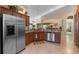 Kitchen with stainless steel appliances, and breakfast bar, open to the dining area at 2428 Maverick Way, The Villages, FL 32162