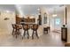 Open kitchen with breakfast bar, dark cabinets, and stainless appliances at 2428 Maverick Way, The Villages, FL 32162