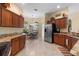 Kitchen with stainless steel refrigerator and granite countertops, open to the eating area at 2428 Maverick Way, The Villages, FL 32162