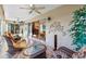 Sunroom featuring tile flooring, comfortable wicker seating, and a ceiling fan at 2428 Maverick Way, The Villages, FL 32162