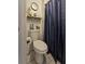 Bathroom featuring toilet with an anchor, navy shower curtain and other nautical decor at 2442 Foxhollow Rd, Tavares, FL 32778