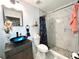 This remodeled bathroom showcases a sleek vessel sink, a walk-in shower, and modern fixtures for a spa-like retreat at 2442 Foxhollow Rd, Tavares, FL 32778