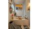 Relaxing bathroom features an oversized tub, beach-themed decorations, and plenty of natural light for a spa-like experience at 2442 Foxhollow Rd, Tavares, FL 32778