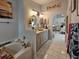 Elegant bathroom featuring a soaking tub, double vanity, and stylish decor with an open view to the bedroom at 2442 Foxhollow Rd, Tavares, FL 32778