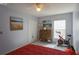 Bright bedroom with white tile floors, ceiling fan, art, and exercise bike at 2442 Foxhollow Rd, Tavares, FL 32778