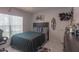 Cozy bedroom features a comfy bed, natural light, and a personalized surf-themed decor for a unique living space at 2442 Foxhollow Rd, Tavares, FL 32778