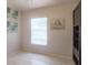 Bright bedroom featuring neutral paint, art, and a large window with bright light at 2442 Foxhollow Rd, Tavares, FL 32778