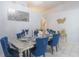 Elegant dining area featuring stylish decor, seating, and modern chandelier with tiled floors at 2442 Foxhollow Rd, Tavares, FL 32778