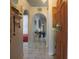 Inviting entryway showcasing a well-lit foyer with decorative arches and elegant tile flooring at 2442 Foxhollow Rd, Tavares, FL 32778