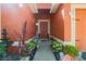 Inviting front entrance with a decorative fountain, lush plants, and a vibrant door at 2442 Foxhollow Rd, Tavares, FL 32778