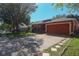 Exterior view of a one-story home showing the driveway and front yard at 2442 Foxhollow Rd, Tavares, FL 32778