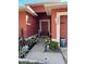 Inviting front porch features fresh landscaping, a red door, and a well-maintained walkway at 2442 Foxhollow Rd, Tavares, FL 32778
