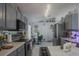 Stylish kitchen featuring gray cabinets, stainless steel appliances, and a bright, open layout at 2442 Foxhollow Rd, Tavares, FL 32778