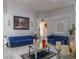 Beautiful living room with bright white walls, tile floors, arched doorways, and blue tufted sofas for a luxurious feel at 2442 Foxhollow Rd, Tavares, FL 32778