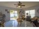 Cozy living room with sliding glass doors leading to the backyard, offering natural light and garden views at 2442 Foxhollow Rd, Tavares, FL 32778