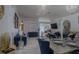 Spacious living room featuring stylish blue furniture, elegant chandeliers, and bright, open design at 2442 Foxhollow Rd, Tavares, FL 32778
