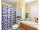 Bathroom featuring a blue patterned shower curtain, a toilet, and a vanity at 2488 Ansley Path, The Villages, FL 32162