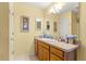 Bathroom features a single vanity and framed mirrors above the counter at 2488 Ansley Path, The Villages, FL 32162