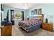 This bedroom features a window, art, and a wooden headboard at 2488 Ansley Path, The Villages, FL 32162