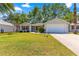 Charming single-story home with a well-maintained lawn and attached two car garage at 2488 Ansley Path, The Villages, FL 32162
