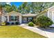 Inviting home with manicured landscaping and cozy entryway, featuring a charming front garden at 2488 Ansley Path, The Villages, FL 32162