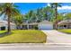 Landscaped single-story home featuring a two-car garage and well-manicured front lawn at 2488 Ansley Path, The Villages, FL 32162