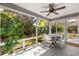 Screened lanai with ceiling fan provides serene views of the lush backyard at 2488 Ansley Path, The Villages, FL 32162