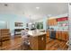 Open living area featuring hardwood floors and a view to the kitchen and dining areas at 2488 Ansley Path, The Villages, FL 32162