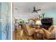 Bright living room with hardwood floors, a ceiling fan, and an open floor plan at 2488 Ansley Path, The Villages, FL 32162