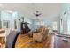 Cozy living room features hardwood floors and an open floor plan, creating a warm atmosphere at 2488 Ansley Path, The Villages, FL 32162