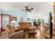 Comfortable living room boasts hardwood floors and blends seamlessly with dining and kitchen at 2488 Ansley Path, The Villages, FL 32162