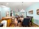 Open-concept living space blends dining and kitchen areas, featuring hardwood floors and natural light at 2488 Ansley Path, The Villages, FL 32162