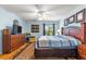Spacious bedroom with wood floors, ceiling fan and natural light at 2488 Ansley Path, The Villages, FL 32162