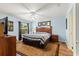 Bedroom featuring wood floors, fan and an exterior view from the window at 2488 Ansley Path, The Villages, FL 32162