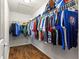Spacious walk-in closet with wood floors and ample hanging storage for clothes and accessories at 2488 Ansley Path, The Villages, FL 32162