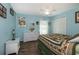 Bright bedroom with wood flooring, large closet, and white wicker furniture at 27121 Greenfly Orchid Ln, Leesburg, FL 34748