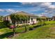 Home exterior highlighting the well-maintained landscaping, screened lanai, and tidy lawn at 27121 Greenfly Orchid Ln, Leesburg, FL 34748