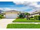 Charming single-story home boasts a well-manicured lawn and vibrant landscaping at 27121 Greenfly Orchid Ln, Leesburg, FL 34748