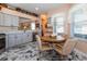 Eat-in kitchen area bathed in light with gray marbled tile flooring at 27121 Greenfly Orchid Ln, Leesburg, FL 34748