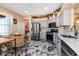 Charming kitchen with stainless steel appliances, light-colored cabinetry, and marble tile floor at 27121 Greenfly Orchid Ln, Leesburg, FL 34748