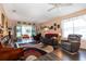 Spacious living room with lots of seating and natural light at 27121 Greenfly Orchid Ln, Leesburg, FL 34748