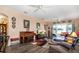 Comfortable living room featuring wood-look floors and neutral decor at 27121 Greenfly Orchid Ln, Leesburg, FL 34748