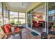 Bright sun room with wicker furniture and tile flooring at 27121 Greenfly Orchid Ln, Leesburg, FL 34748