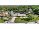 An aerial shot showcases the home's waterfront location, lush greenery, and proximity to the surrounding neighborhood at 28416 Tammi Dr, Tavares, FL 32778