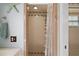 Bathroom showcasing walk-in shower with glass doors and tiled walls at 28416 Tammi Dr, Tavares, FL 32778